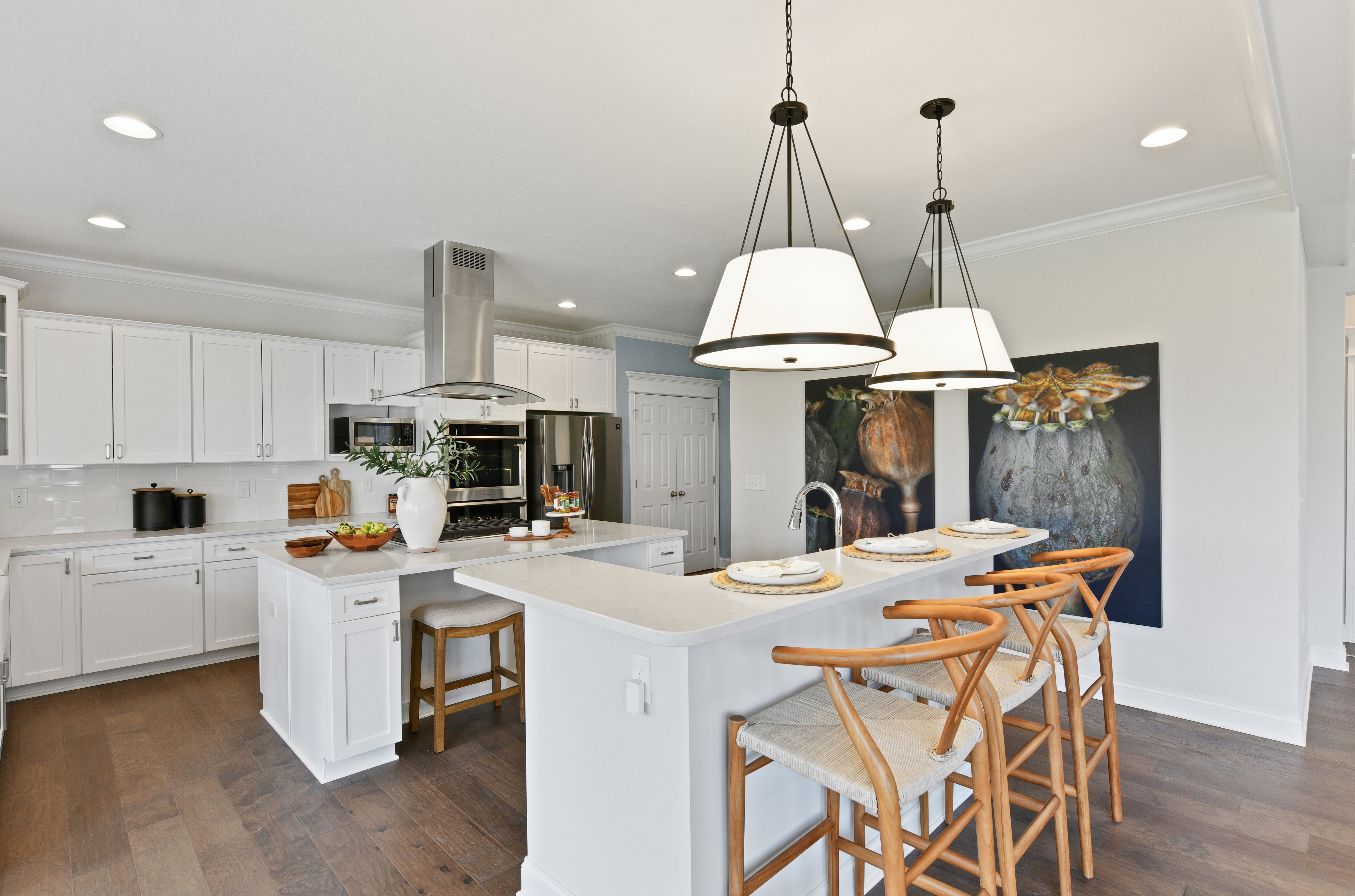 Modern white kitchen with two islands and mixed metal fixutres