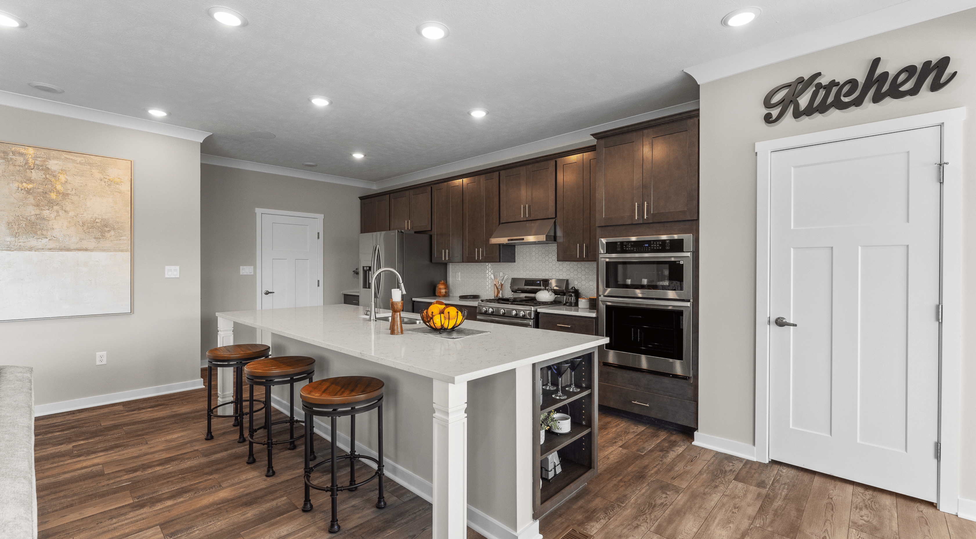 kitchen with a large island and granite countertops in a new home in lebanon, oh