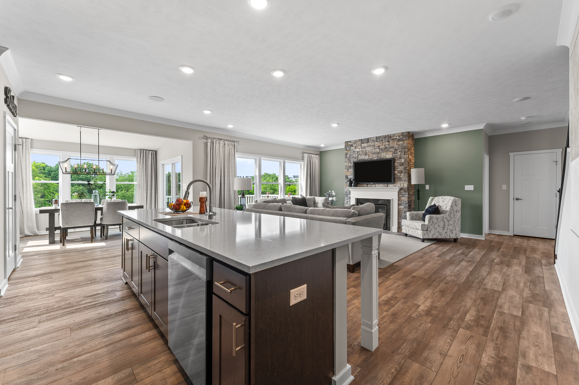 open concept floor plan with view of kitchen into dining area and living room in a new home in lebanon, oh