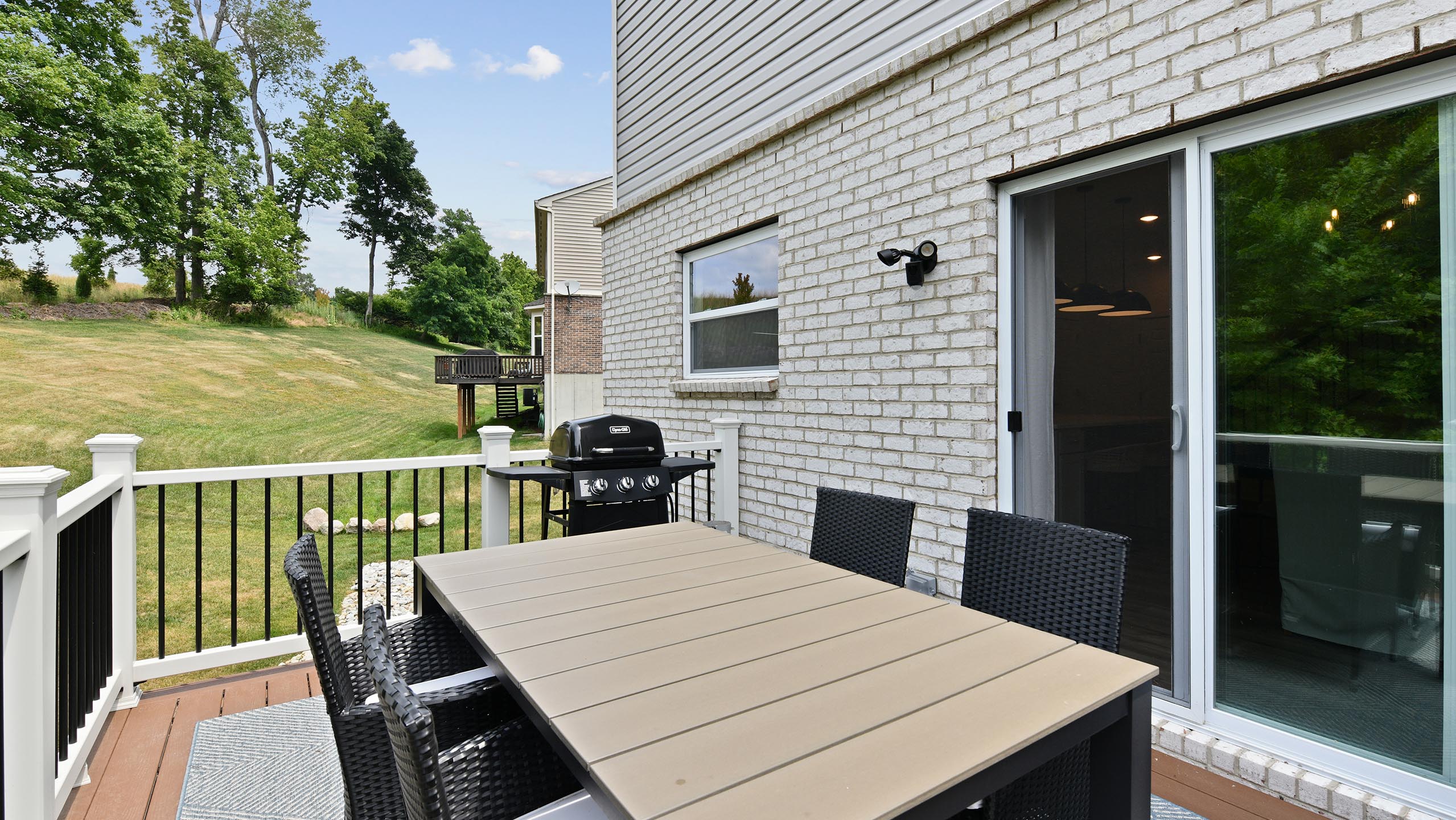 Outdoor deck and sliding door with dining table in Miami Township, OH
