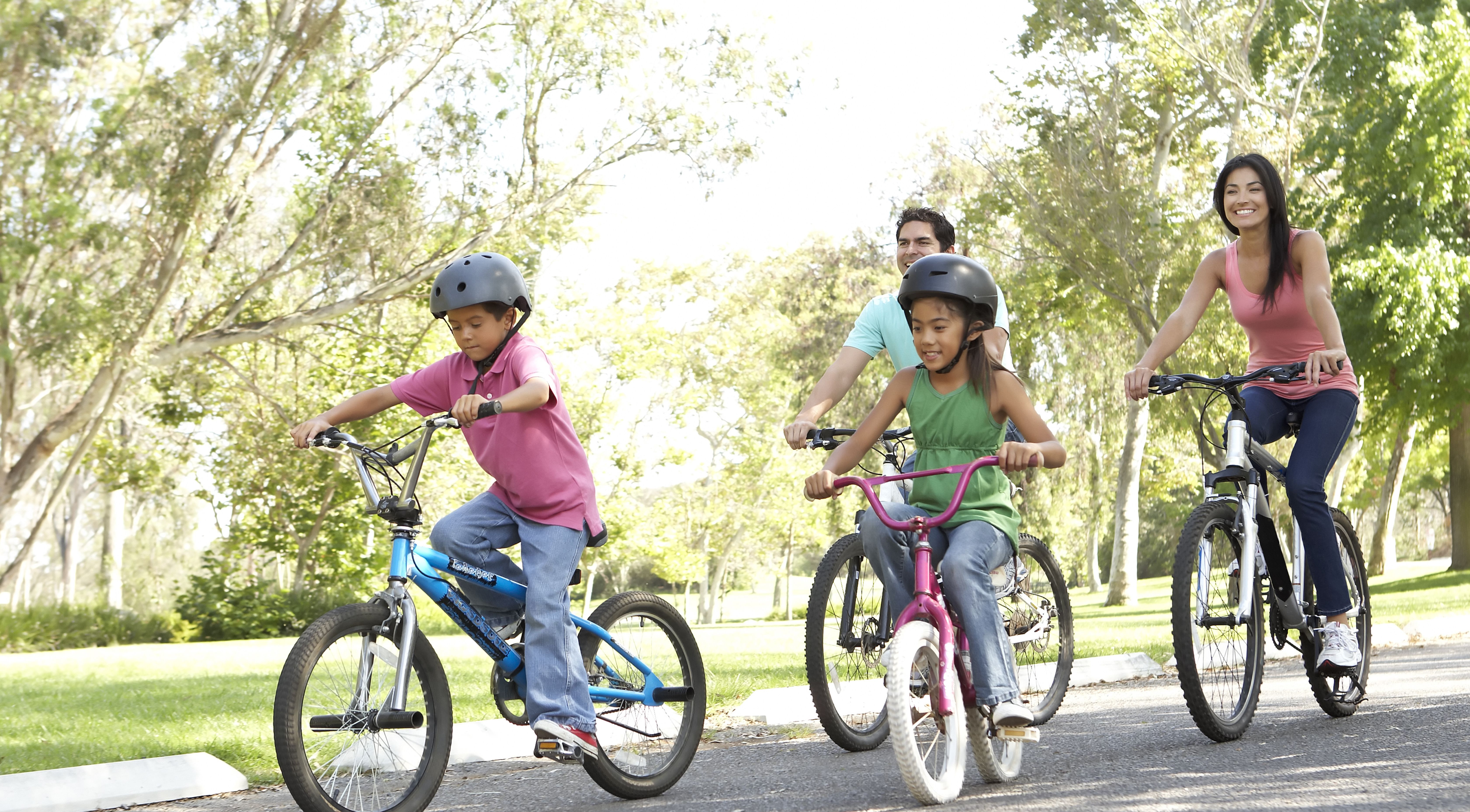 Family of four riding their bikes outdoors in Miami Township, OH