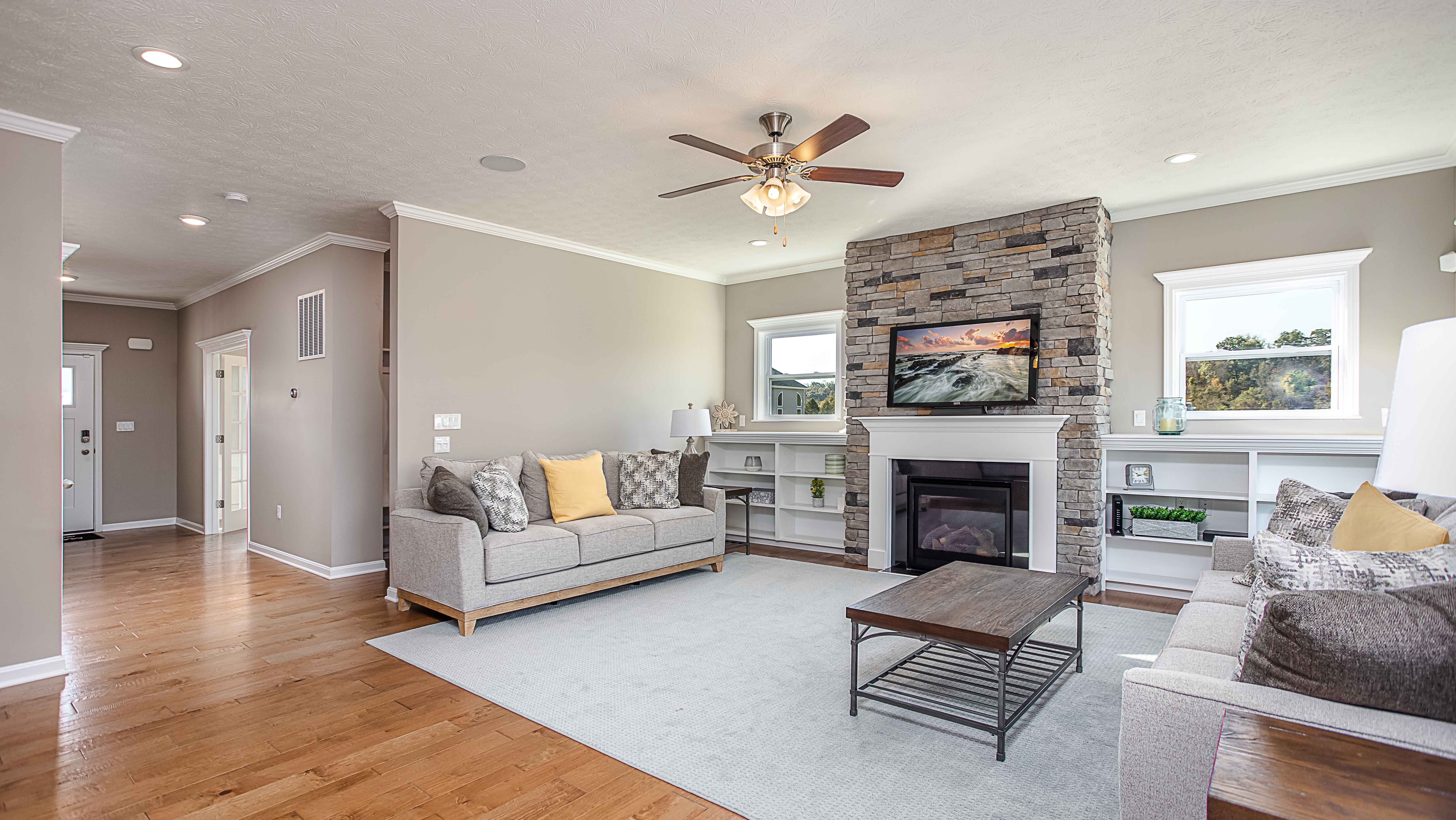 Livingroom with stone fireplace of a new home in Oakdale