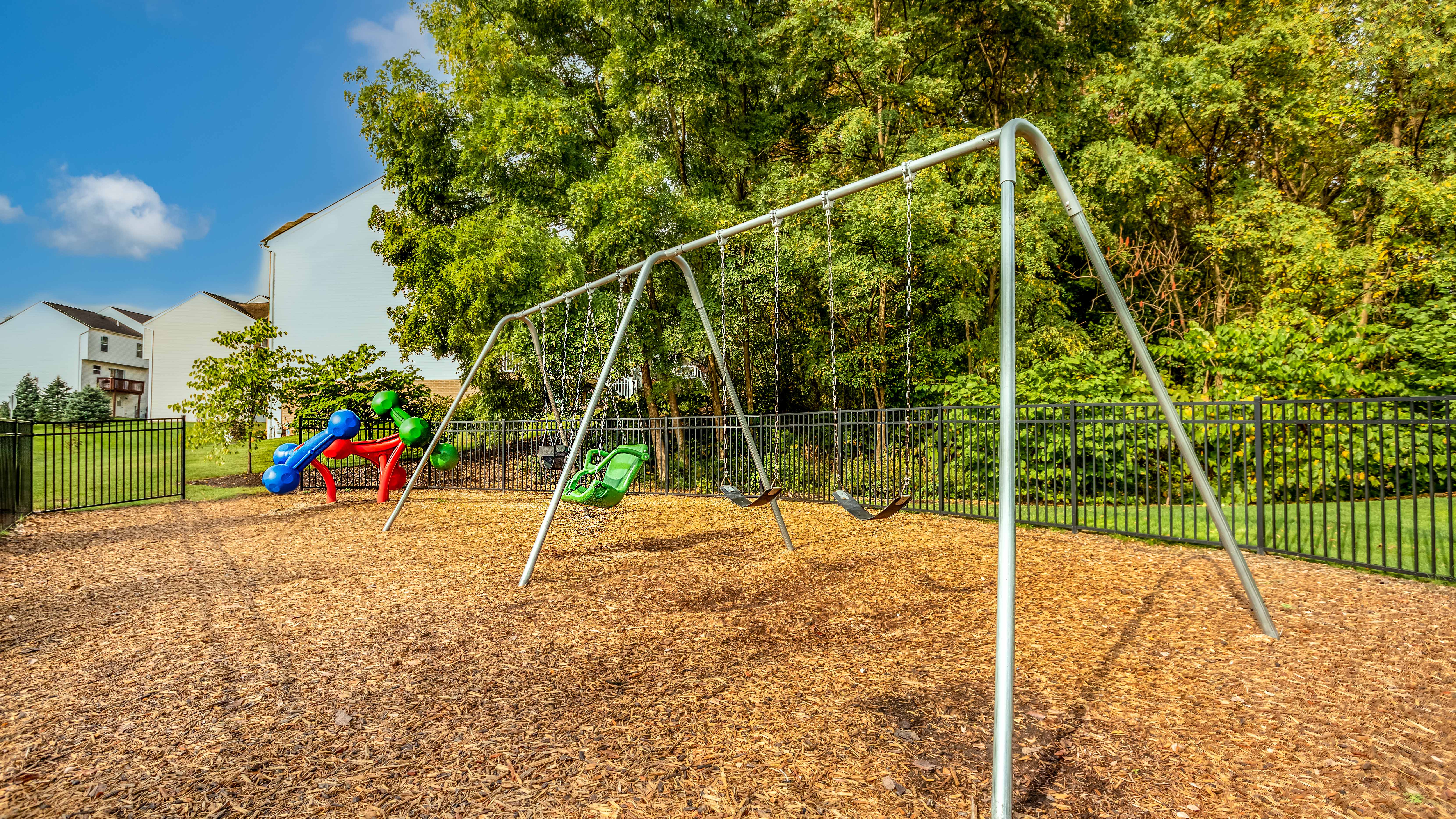 Small park with swings in townhome community in Moon Twp