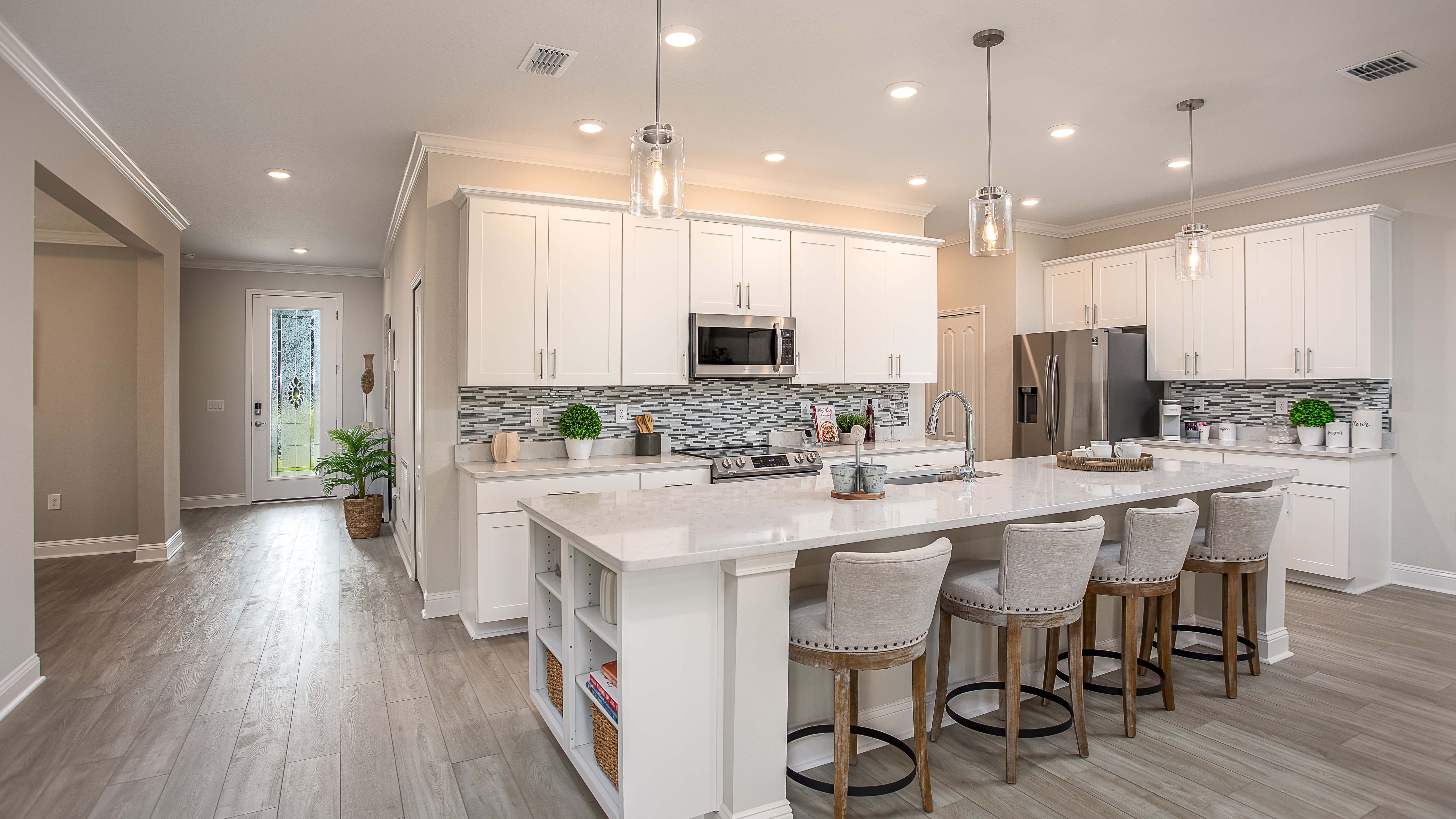 entry way into the white kitchen of a new home in merritt island, fl