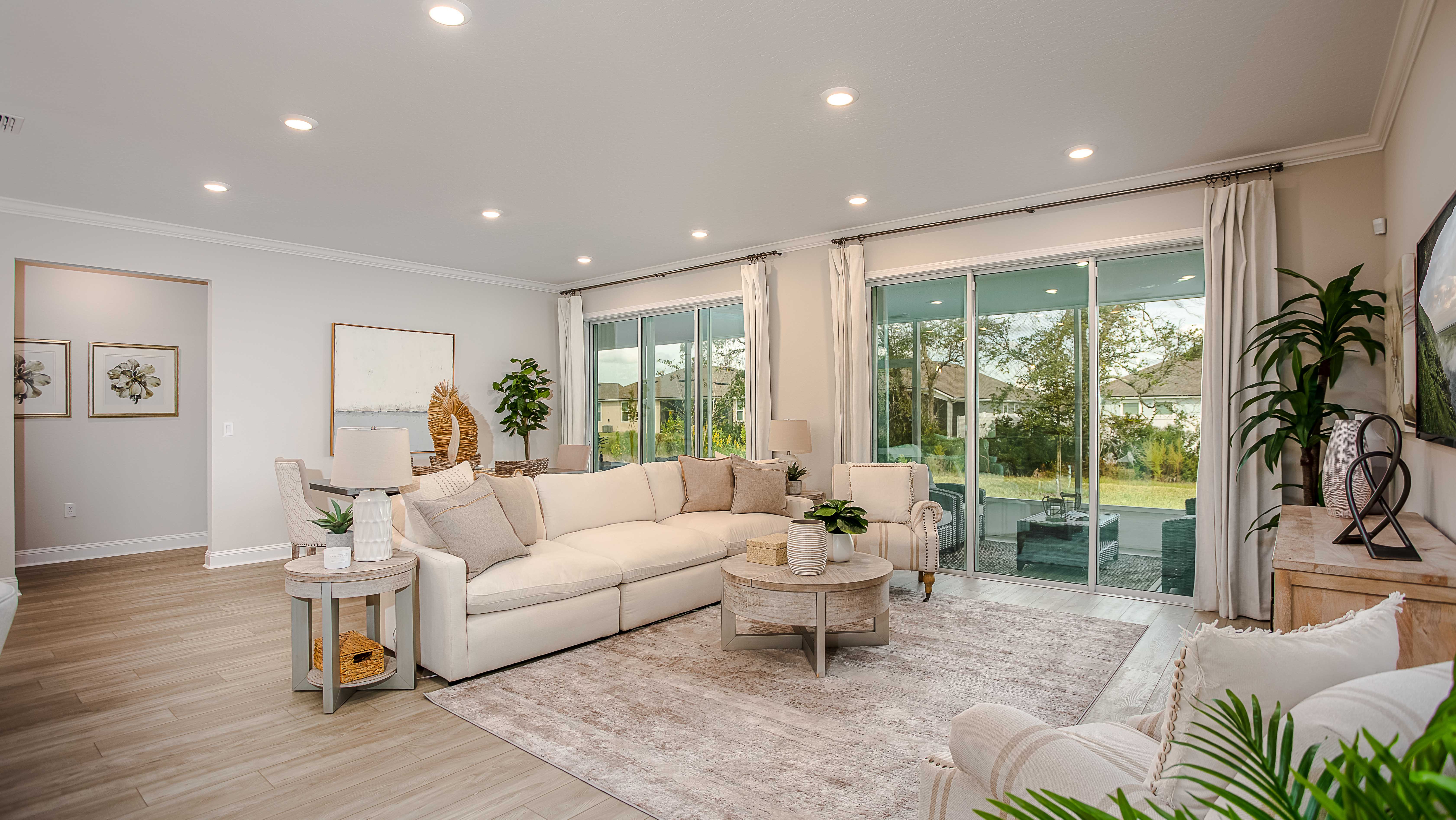 living room with sliding glass door and large windows in a new home in merritt island, fl