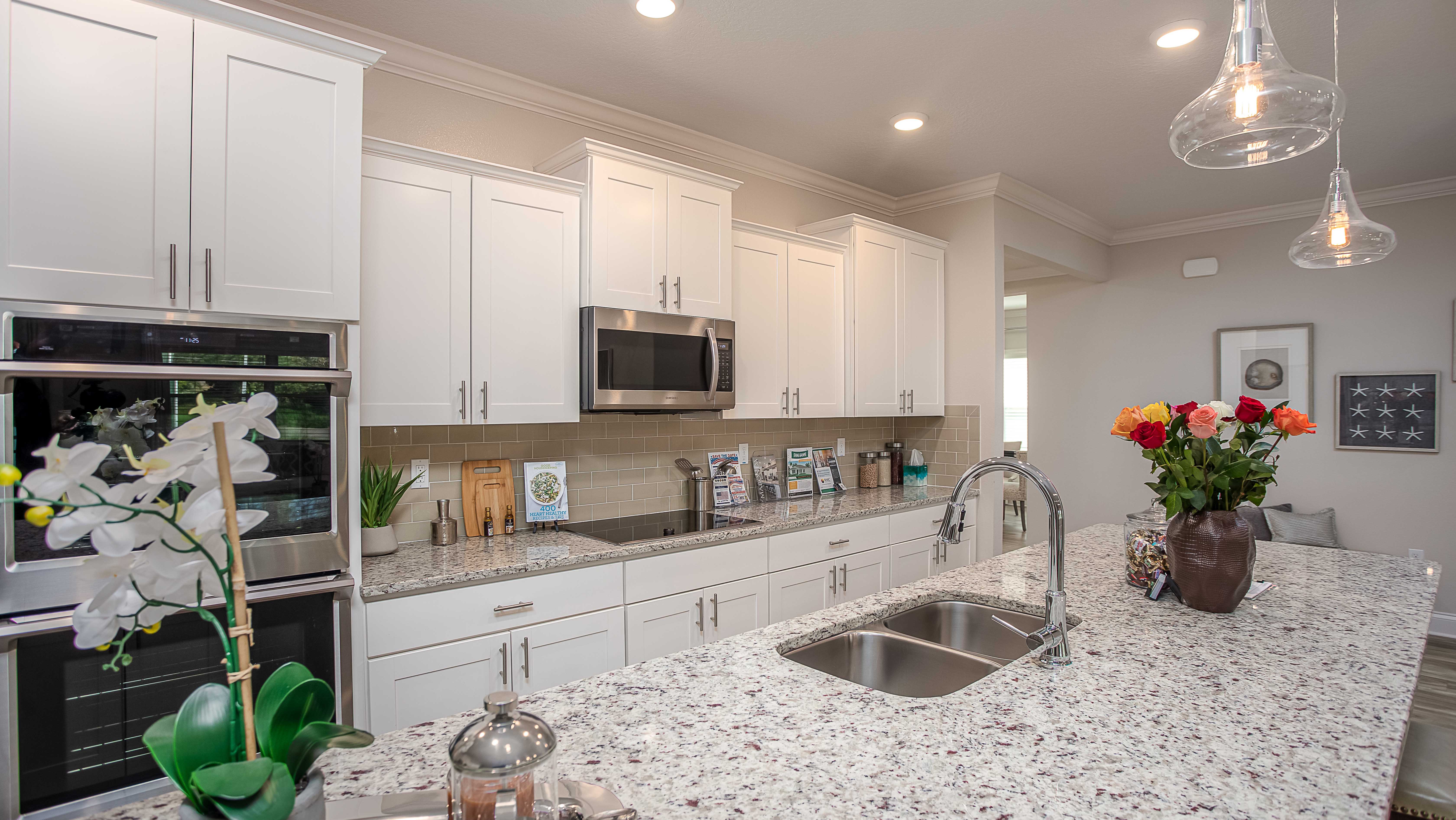 modern white kitchen with granite countertops in a new home in palm coast, fl