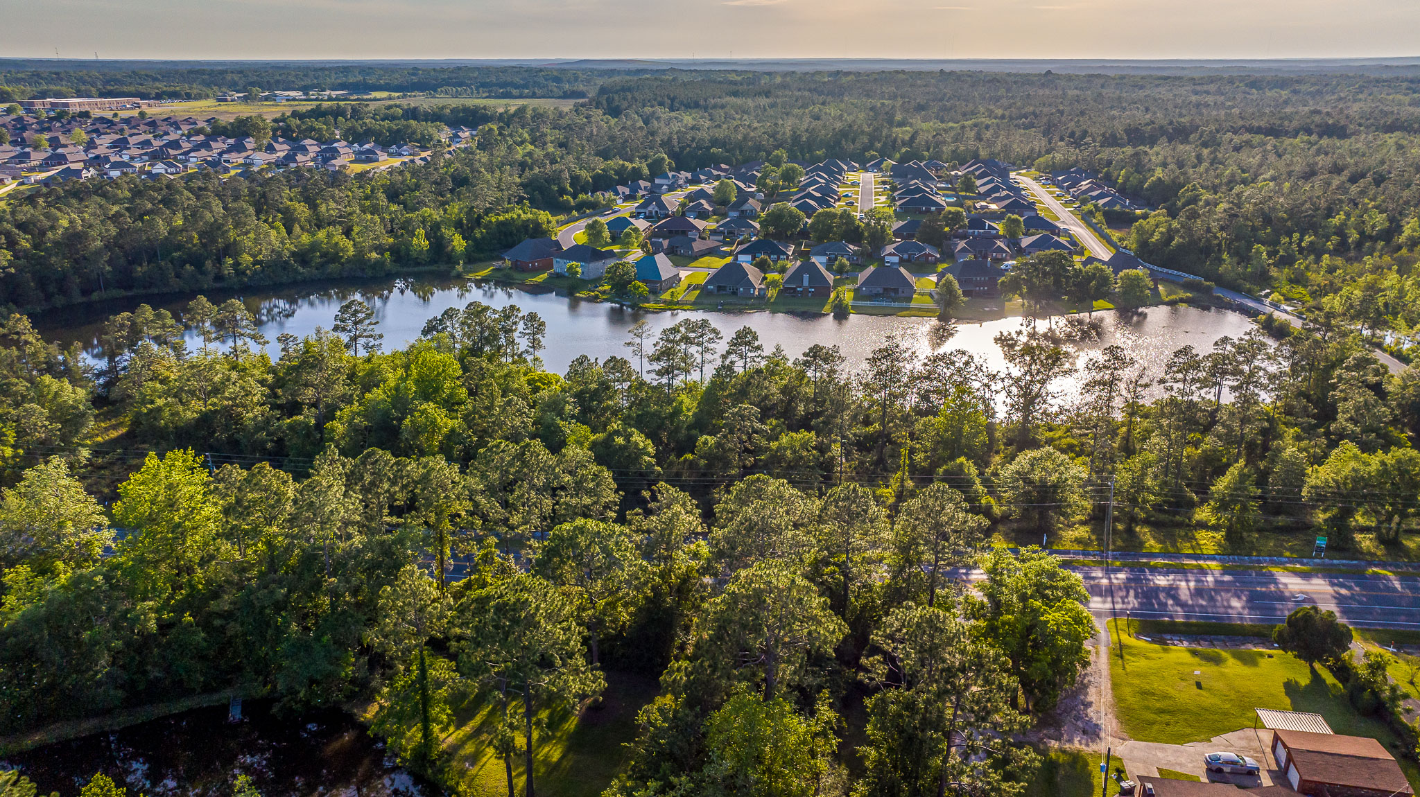 aerial view of trees and lake in cantonment